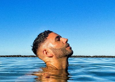 Profile view of a man breathing deeply before an exercise.
